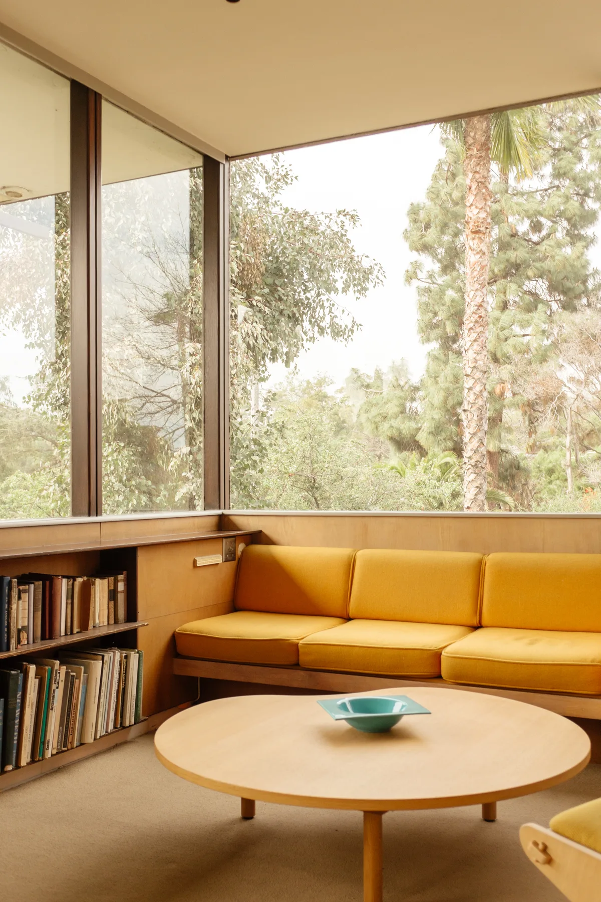 Interior of the Neutra VDL House, Silver Lake: a reflecting pool and glass wall in narrow, layered space.