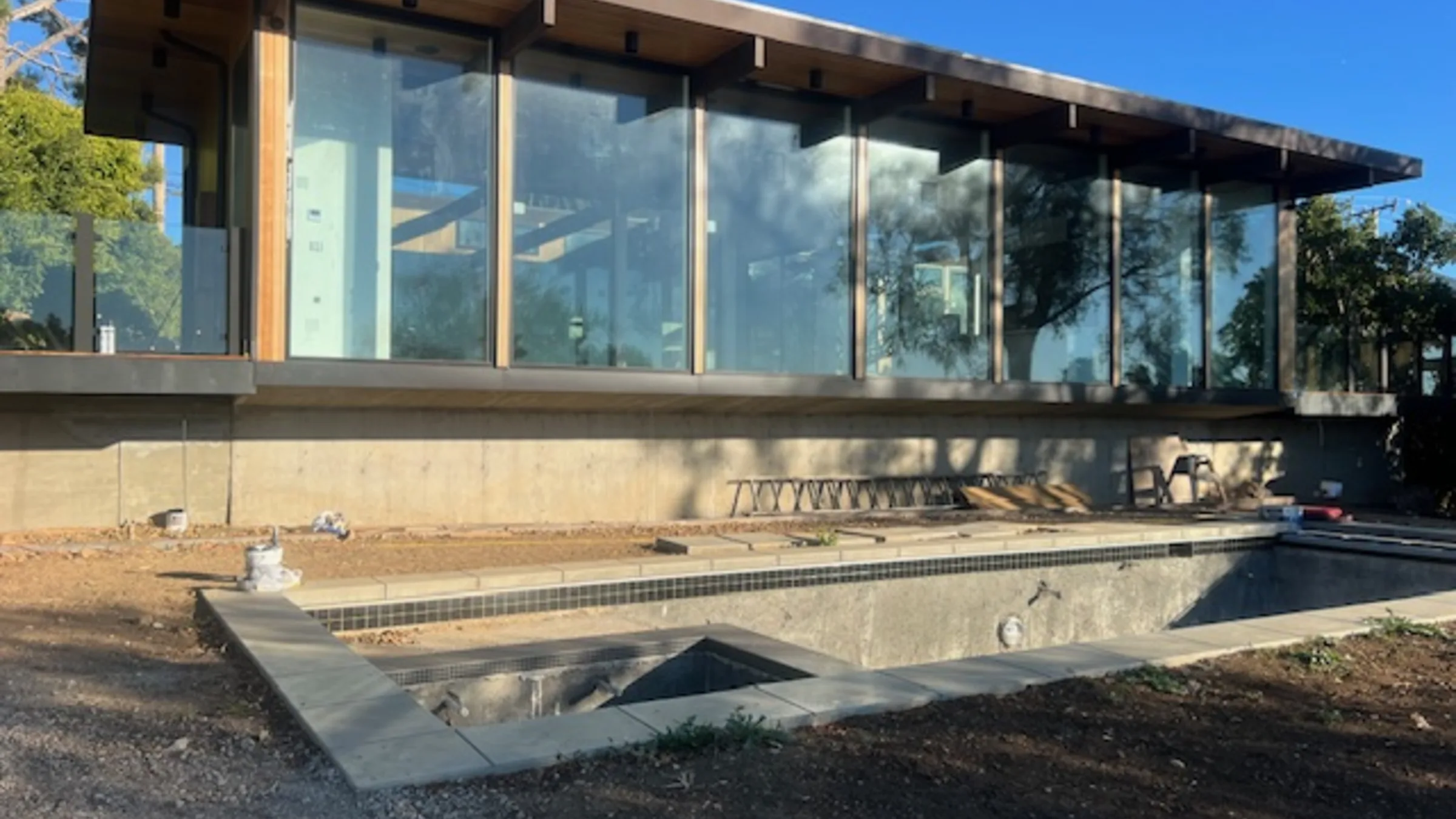 Busch Drive: the glass-and-timber pavilion nearing completion on its Malibu hillside.