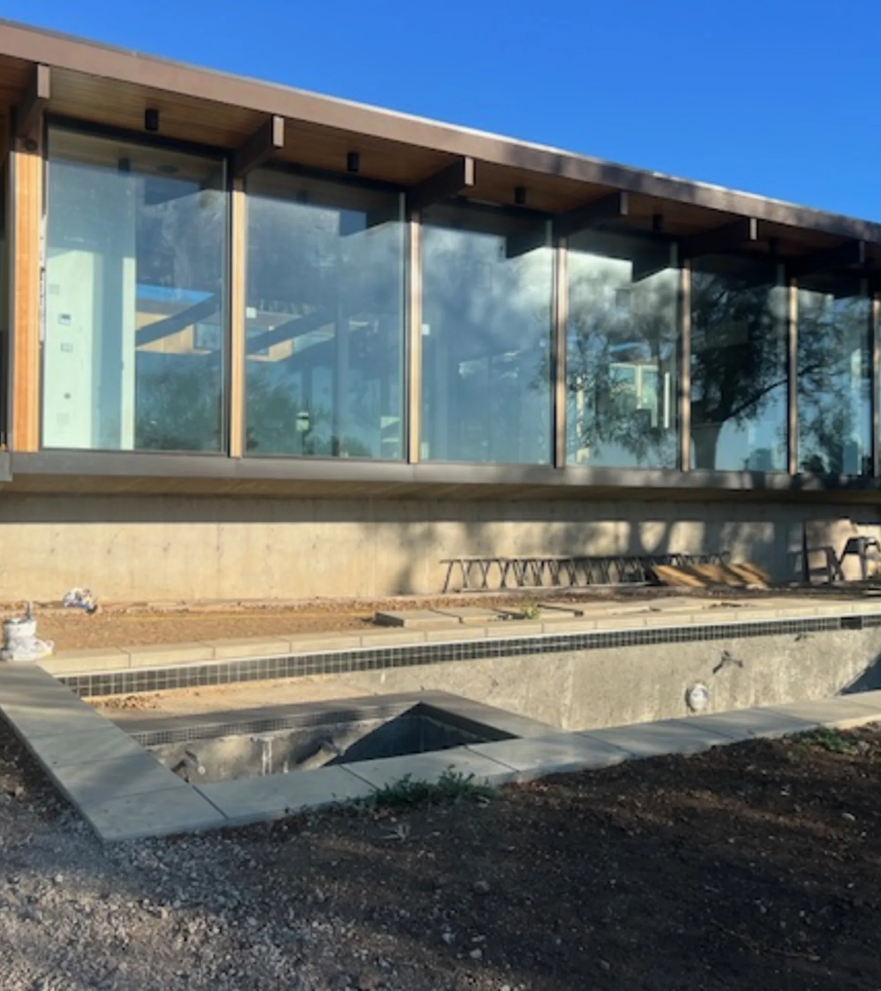 Busch Drive: the glass-and-timber pavilion nearing completion on its Malibu hillside.