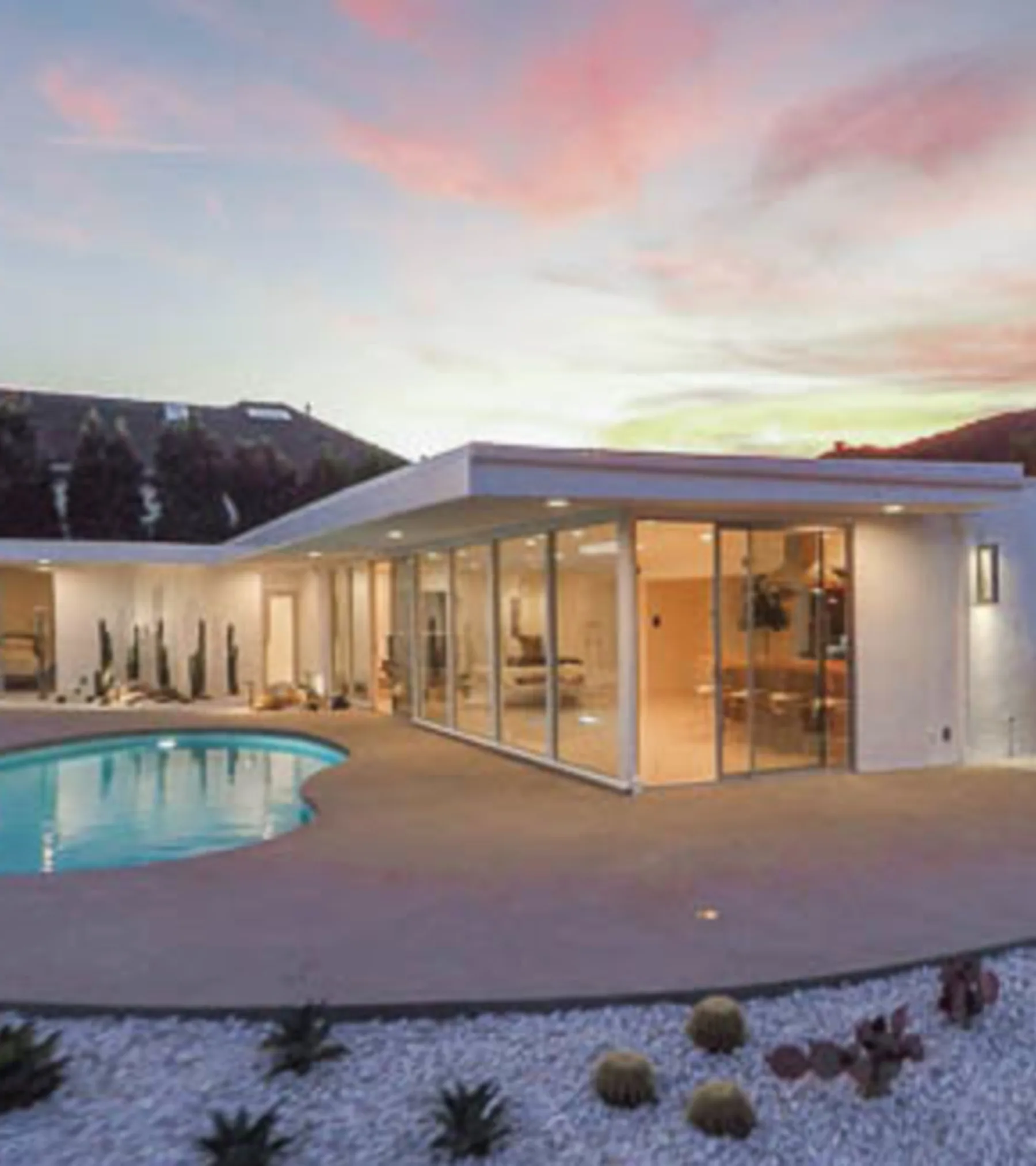 Casiano Road at twilight: the white pavilion glowing through its glass beside the pool, the sky fading over Bel Air.