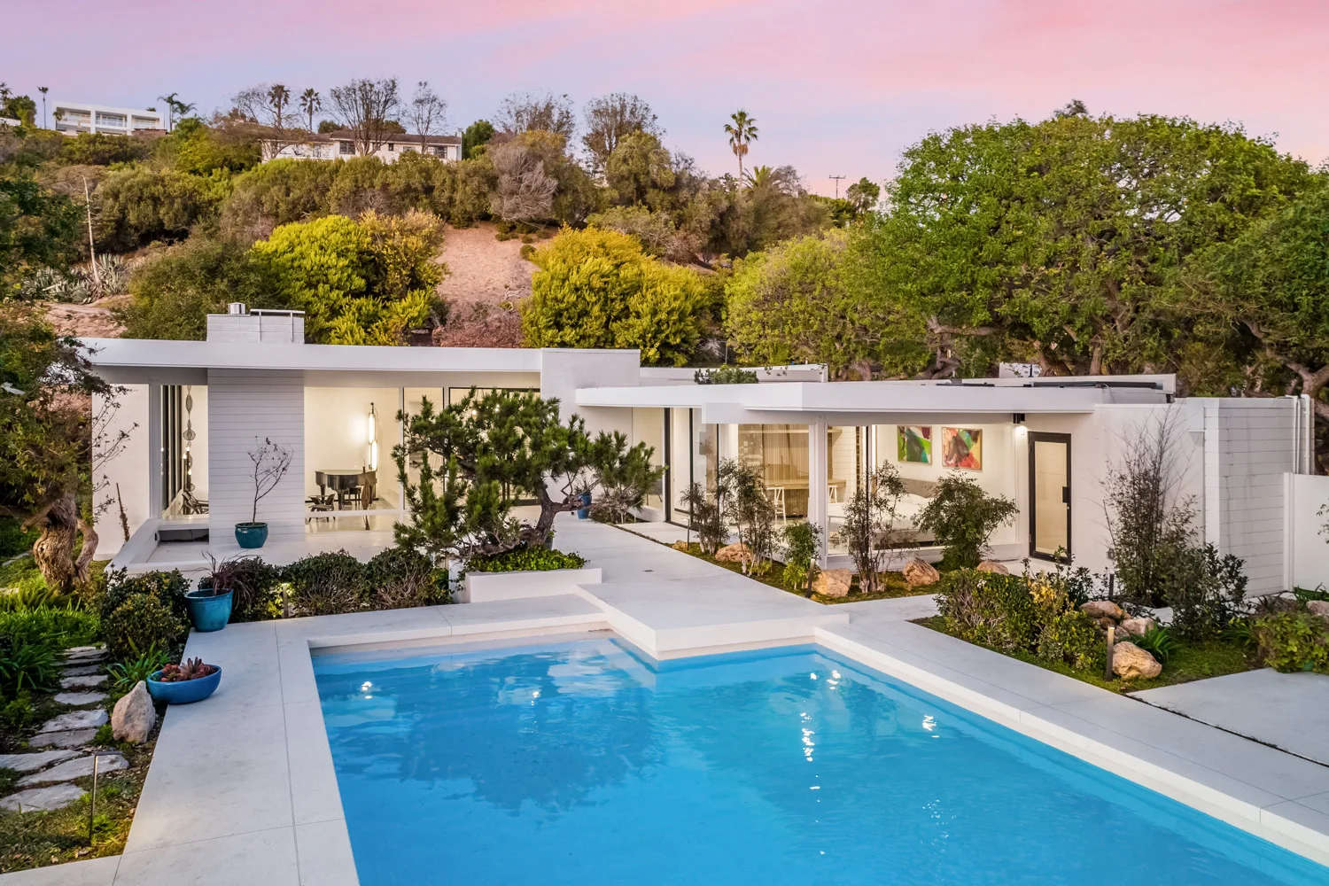The pool and the house from above, at dusk.