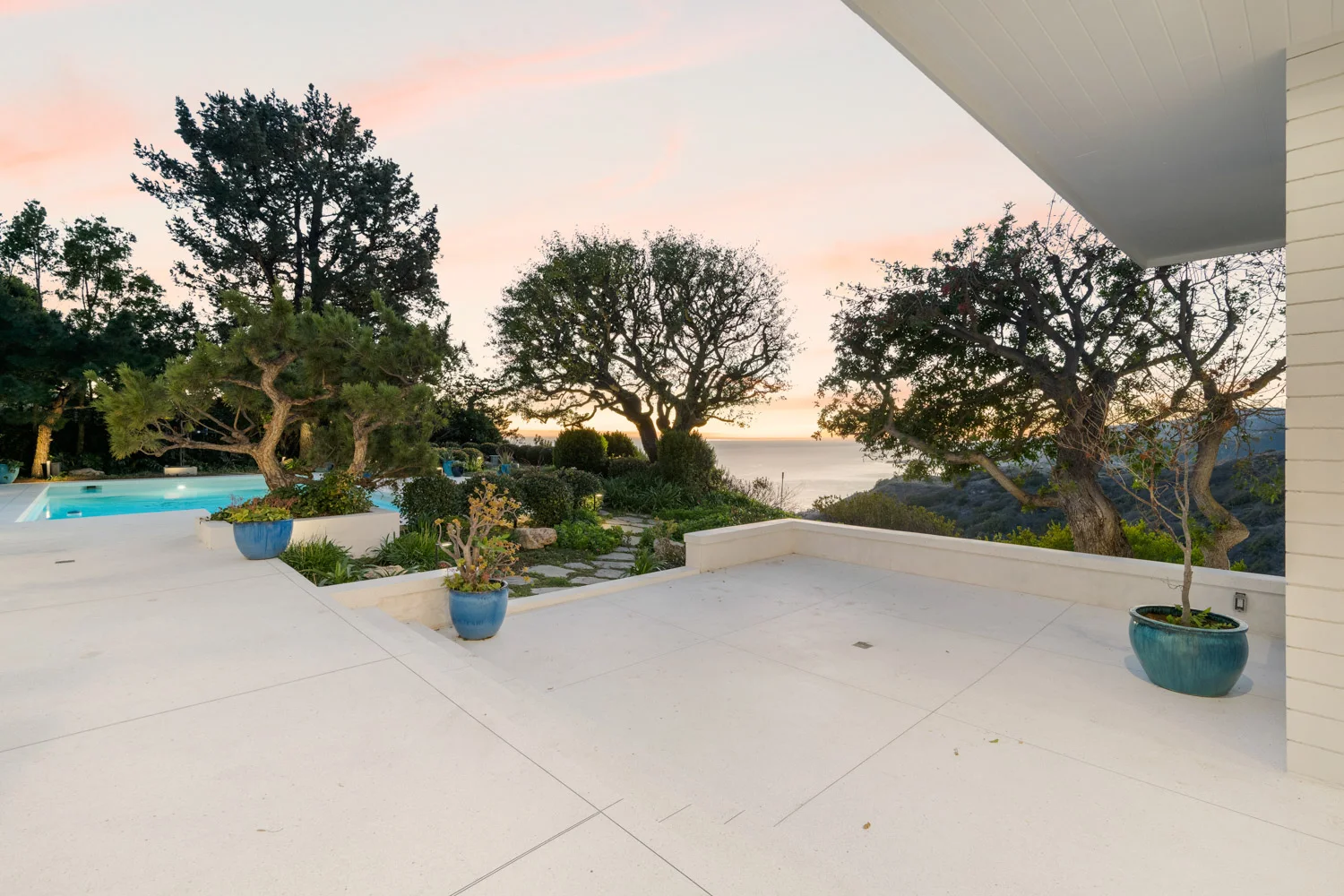 The terrace at sunset, an oak in silhouette.