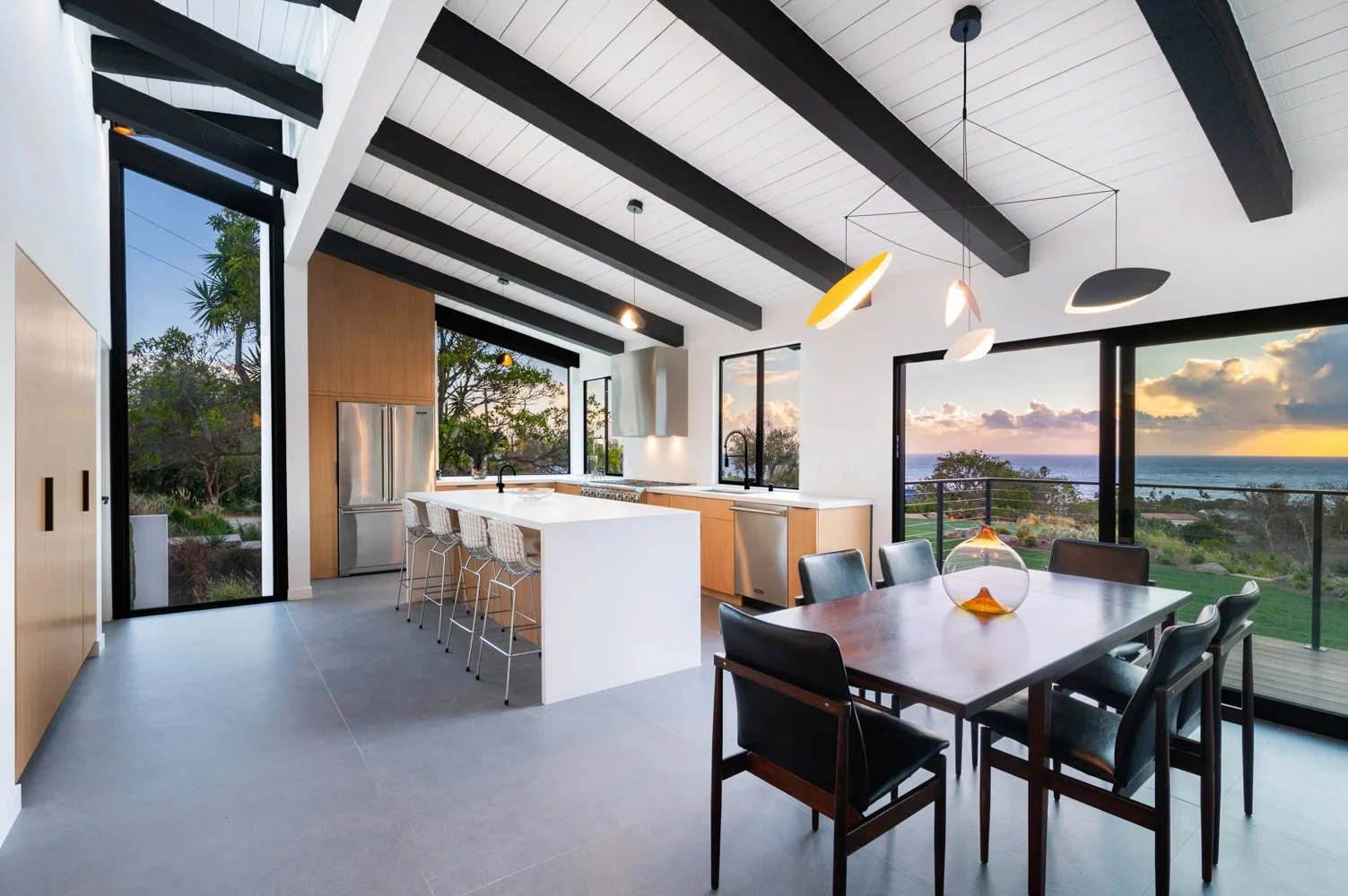 The dining table by the kitchen, the Pacific in the window.