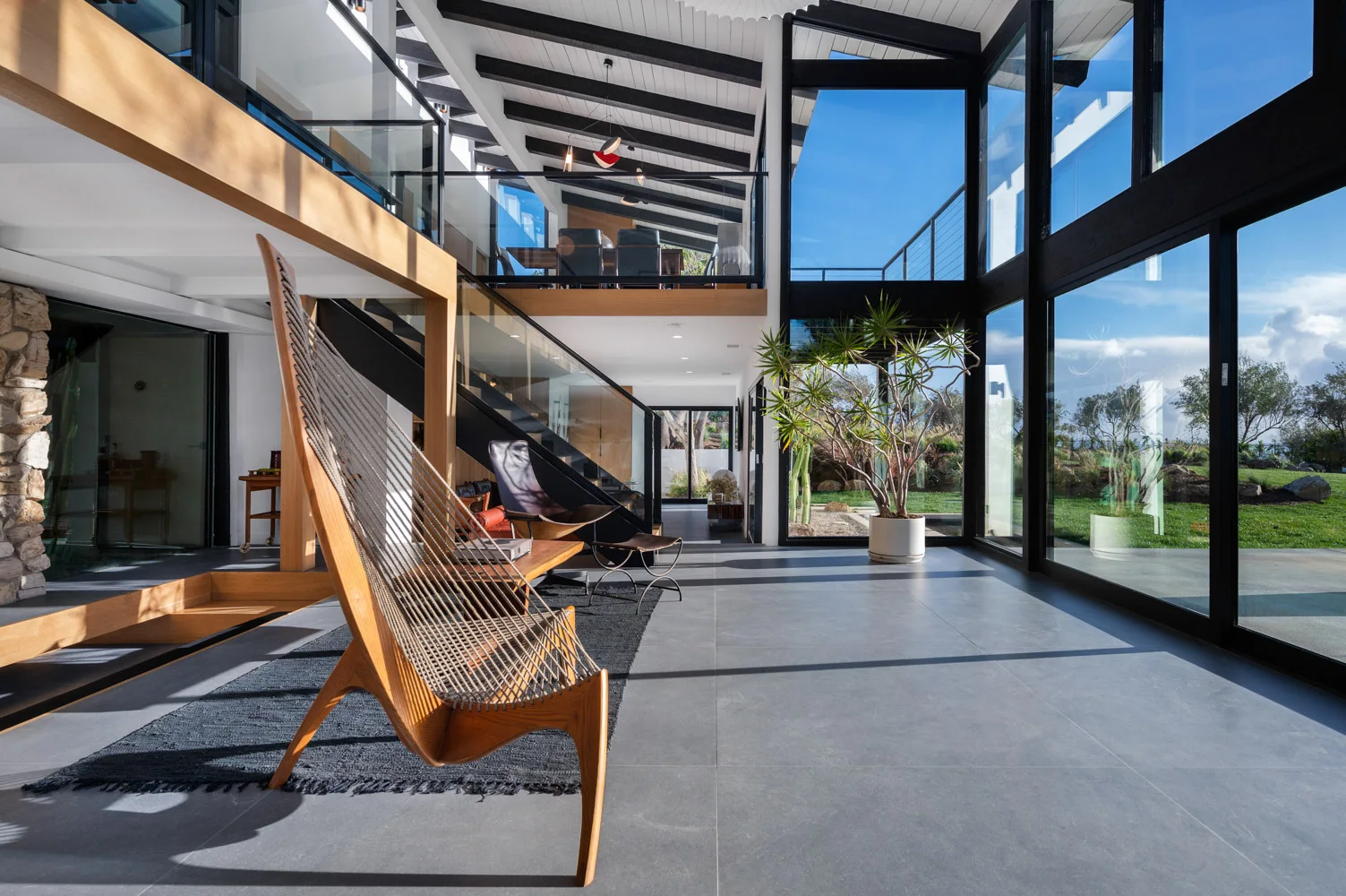 The lounge: a hammock chair and glass walls to the garden.