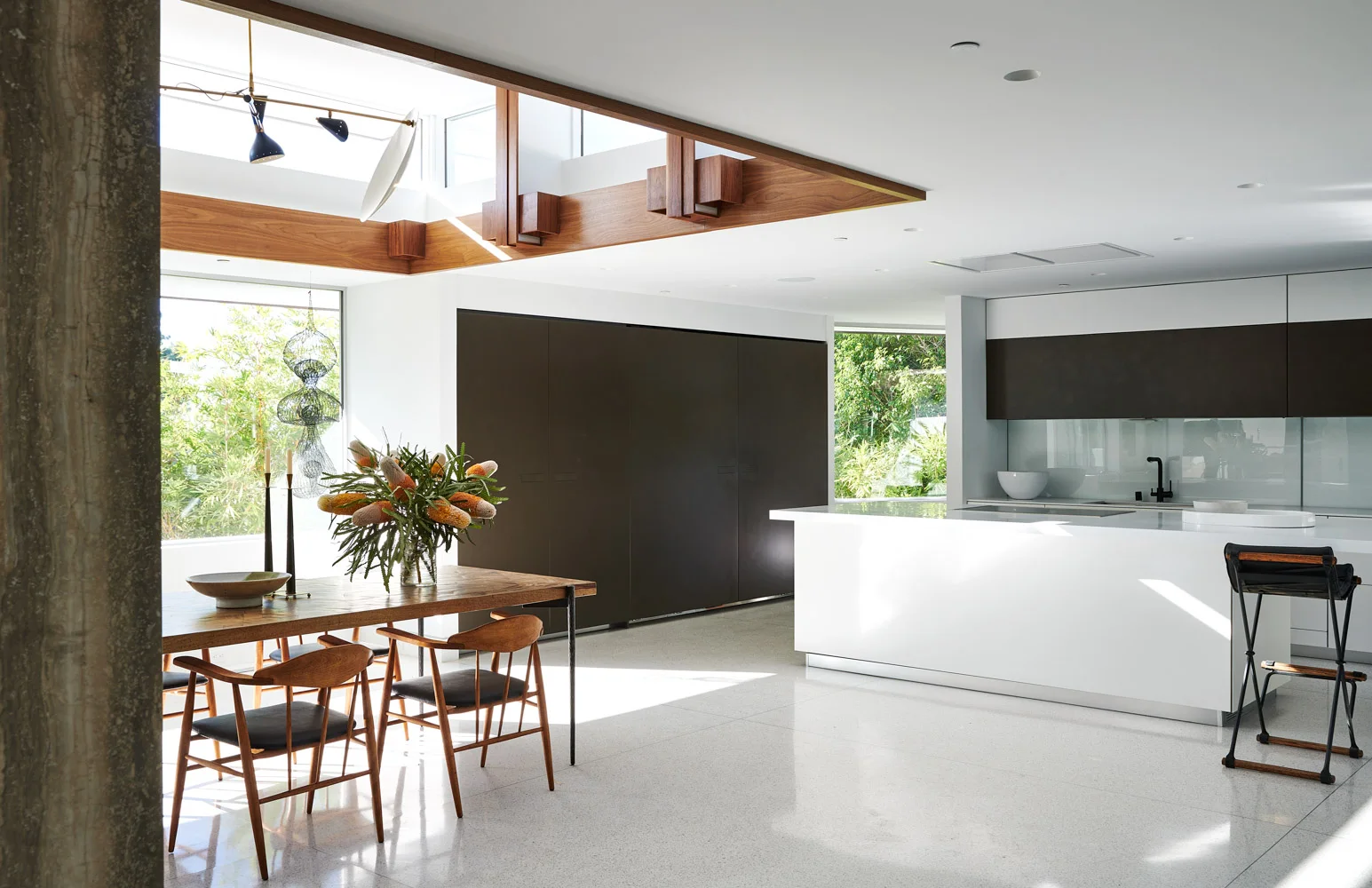 The dining room and kitchen, a black island.