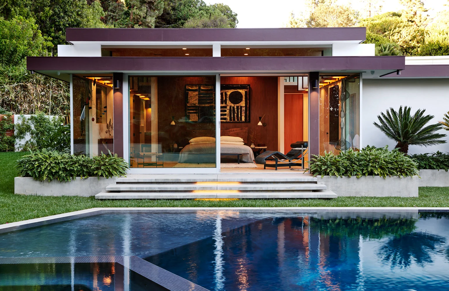 The garden and pool from the house at dusk.