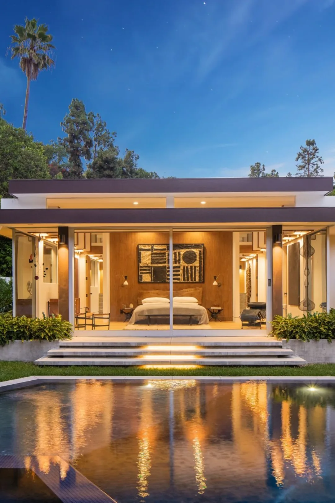 Loma Vista, Beverly Hills, its pool reflecting the lit pavilion at night.