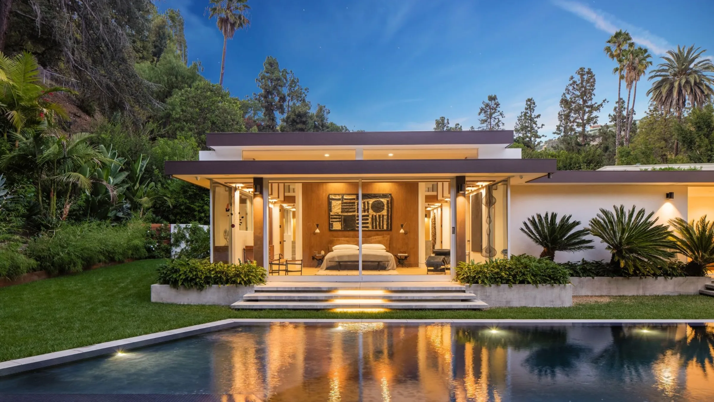 Loma Vista, Beverly Hills, its pool reflecting the lit pavilion at night.