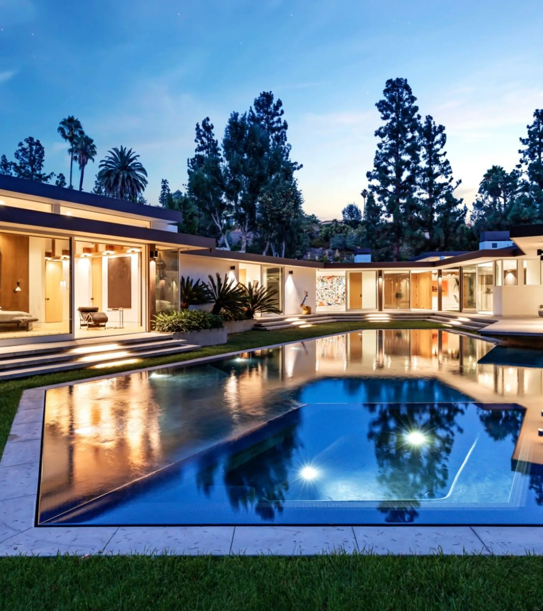 Loma Vista, Beverly Hills, its pool reflecting the lit pavilion at night.