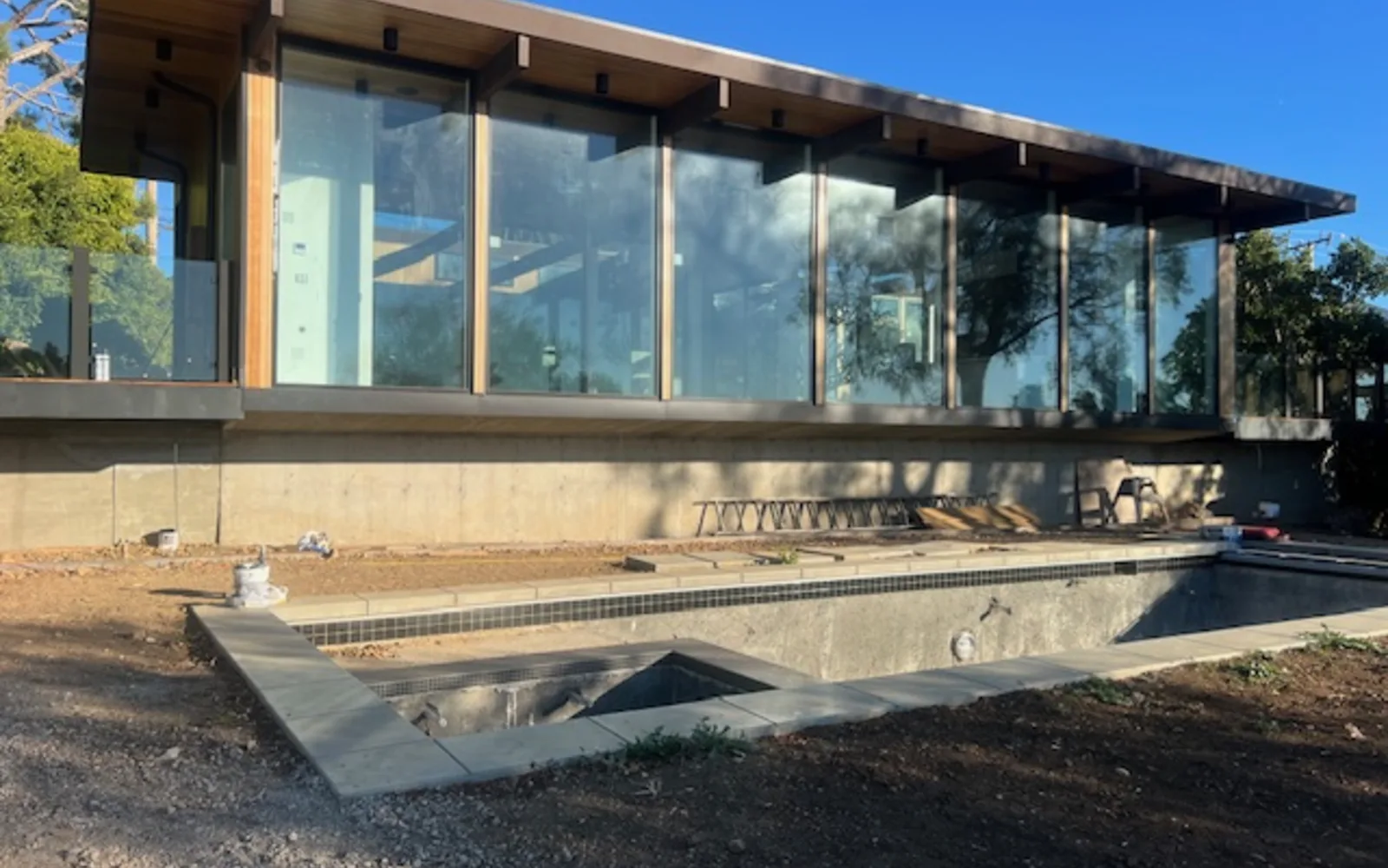 5637 Busch Drive, Malibu, under construction: the glazed pavilion complete, the pool still being excavated.