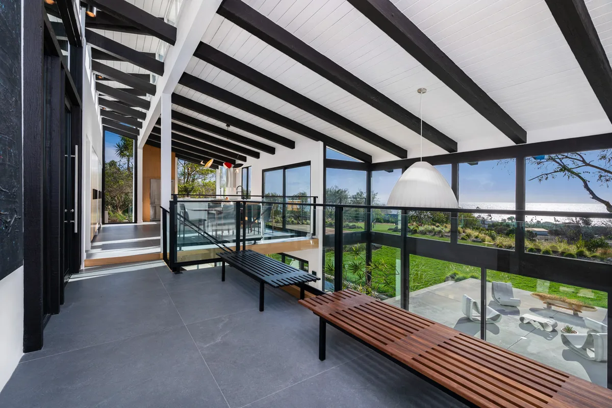 The beamed hall at 5901 Filaree Heights, slatted wood against white.