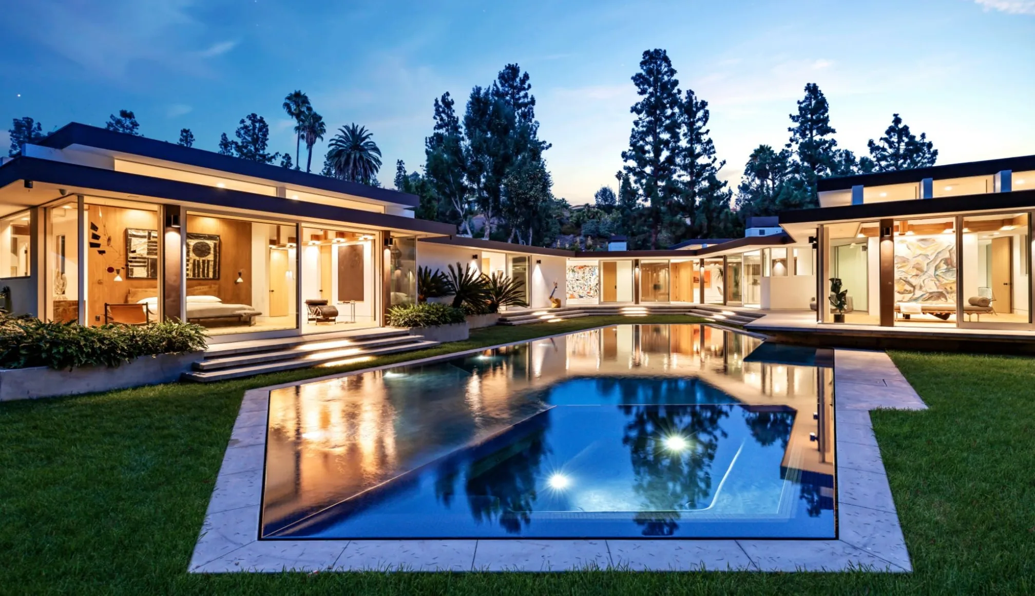 Loma Vista, Beverly Hills, its pool reflecting the lit pavilion at night.